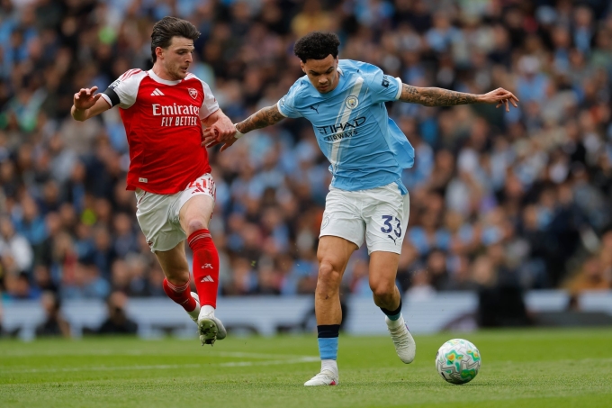 Tiền vệ Arsenal Declan Rice tranh bóng với hậu vệ Man City Nico O’Reilly trong trận đấu trên sân Etihad, Manchester ở vòng 33 Ngoại hạng Anh ngày 19/4. Ảnh: Guardian